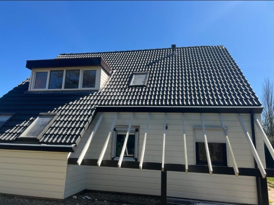 Nieuwbouwwoning met zwart pannendak en dakkapel